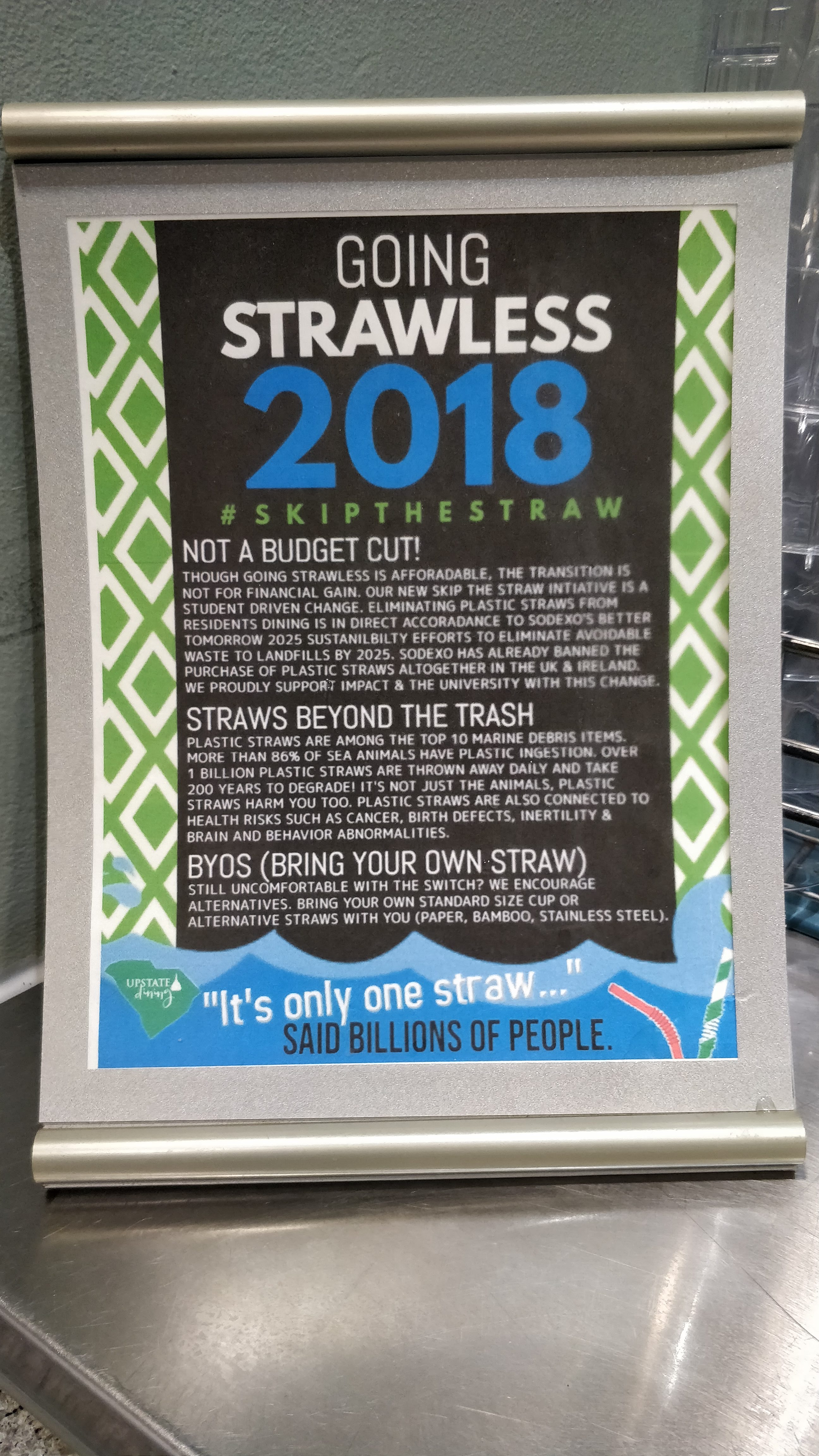 Image of Table-top signs in the cafe after anti-plastic straw service-learning presentations to Dining Services